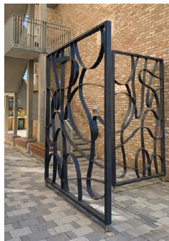 An image showing decorative metal gates, with a curved pattern that creates identity and retains visual permeability. 
