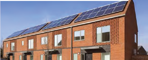 An image of modern terraced houses with solar panels on the roofs. 