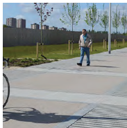 An image of a paved pathway which includes different paving materials. These materials have a similar neutral and grey colour palette. 