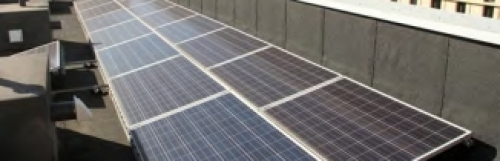 An image of a row of solar panels on top of a roof. 